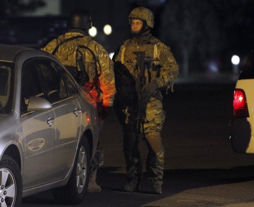 Rick Egan  |  The Salt Lake Tribune

Armed officers at the scene of a shooting on Main Street in Kaysville on  Saturday, March 19, 2011. Joseph Allen Nance was booked into jail Sunday on suspicion of murder in the shooting death of his father, Gregory Allen Nance.