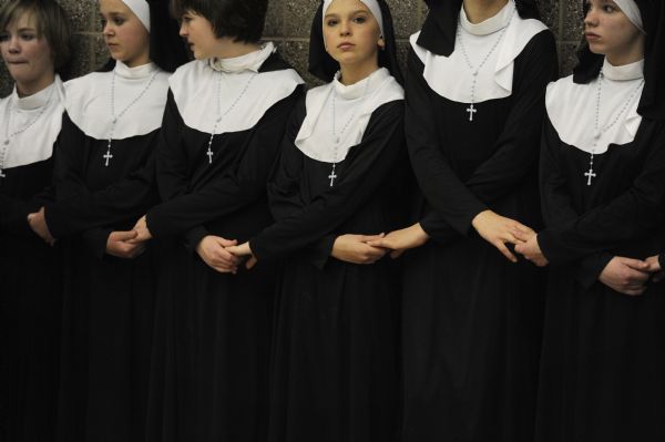 Sarah A. Miller  |  The Salt Lake Tribune

Jamie Lewis, 13, center, holds hands with other girls playing nuns during the moment of silence before their performance of 