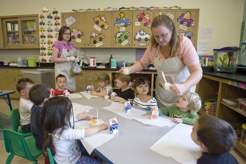 Paul Fraughton  |  The Salt Lake Tribune Tiffany Tanner (left) and Wendy Blanchard, child care providers at South City Child Care, pass out snacks to the children under their care on Monday, March 7, 2011.