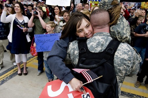 Sarah A. Miller  |  The Salt Lake Tribune

Tiffany Stefl of Farmington hugs her husband, Maj. David Stefl, as he arrives Sunday, March 20, with other members of the Air National Guard's 144th Area Support Medical Company after a 12-month deployment to Afghanistan. They returned to the Air National Guard Base in Salt Lake City.