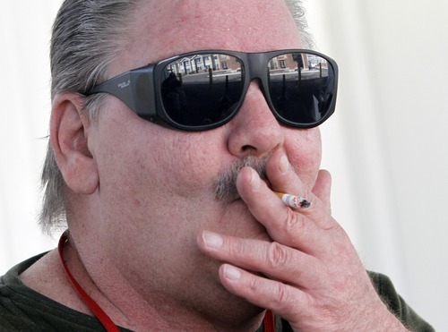 Rick Egan   |  The Salt Lake Tribune
Lloyd Best smokes a cigarette in the smoking area at the Kelly Benson Apartments in West Valley City. Best thinks residents should be allowed to smoke in their rooms.