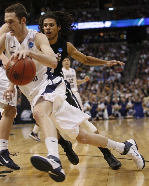 Trent Nelson  |  The Salt Lake Tribune
BYU's Stephen Rogers drives past Gonzaga's Steven Gray as BYU faces Gonzaga in the NCAA Tournament, men's college basketball at the Pepsi Center in Denver, Colorado, Saturday, March 19, 2011.