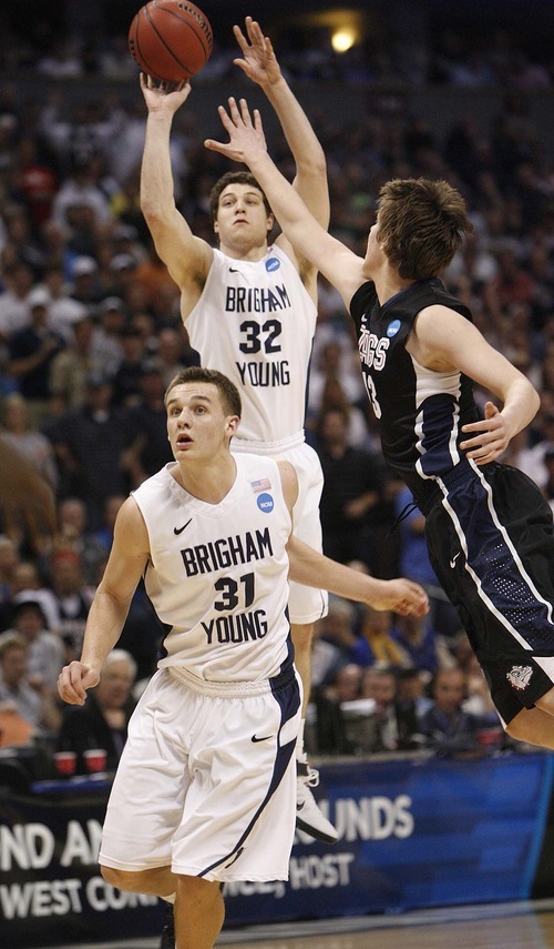 Trent Nelson  |  The Salt Lake Tribune
BYU's Jimmer Fredette puts up a shot with Gonzaga's Kelly Olynyk defending, as BYU faces Gonzaga in the NCAA Tournament, men's college basketball at the Pepsi Center in Denver, Colorado, Saturday, March 19, 2011. At bottom is BYU's Kyle Collinsworth.