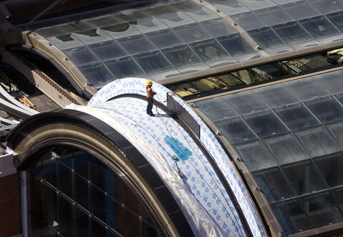 Al Hartmann   |  The Salt Lake Tribune 
Construction worker gives scale to the size of the City Creek Center's huge retractable roof panels on Main Street.