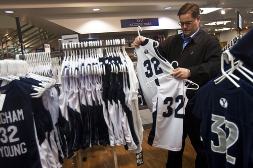 Chris Detrick | The Salt Lake Tribune 
Scott Harris, of American Fork, looks for Jimmer Fredette jerseys for his kids at the BYU Bookstore. In the home of the Cougars, merchandise is flying off shelves.