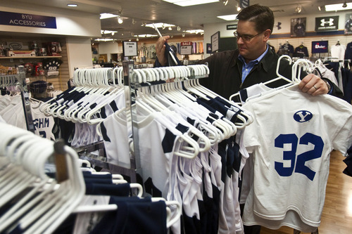 Chris Detrick | The Salt Lake Tribune 
Scott Harris, of American Fork, looks at BYU basketball jerseys for sale at the BYU Bookstore on Wednesday March 23, 2011. Harris was buying Jimmer Fredette jerseys for his four kids.