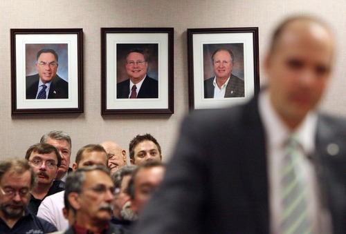 Steve Griffin  |  The Salt Lake Tribune
Provo deputy mayor Corey Norman talks to the Utah Liquor Commission on Thursday about the economic importance of the Provo liquor store, which could be closed because of budget cuts. Portraits of Utah liquor commission members Sam Granato, Richard J. Sperry and Gordon Strachan hang on the wall behind.