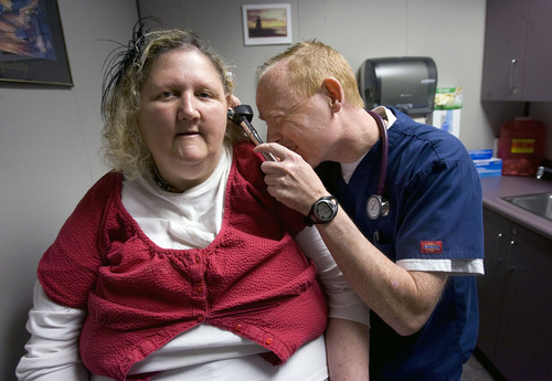 Al Hartmann   |  The Salt Lake Tribune 
Medicaid patient Michelle Huggins has her ears checked during an exam by nurse practitioner Steven Mickelson at Health Clinic of Utah-Provo at 150 E. Center St. in Provo.  The Utah Legislature voted to close this health clinic, which treats Medicaid patients.