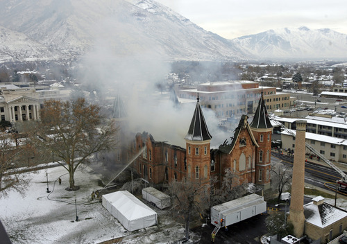 Rick Egan   |  The Salt Lake Tribune

Provo firefighters shoot water on the flames on the north side of the Provo Tabernacle, Friday, Dec. 17, 2010. A painting of Jesus had been badly scorched in the blaze -- save for Christ's image, which was left nearly untouched by the flames. Some considered this a miracle.