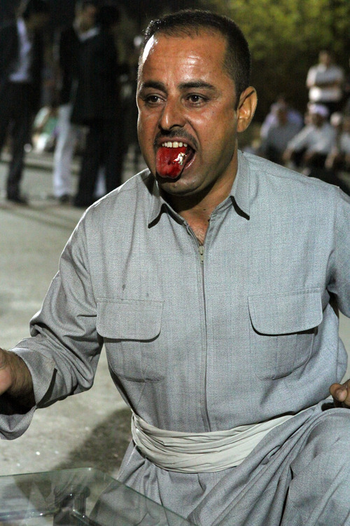 Cindy Hosea  |  Special to The Salt Lake Tribune

A Sufi man displays his cut tongue during a religious ceremony in September, 2010.