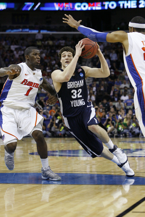 Scott Sommerdorf  |  The Salt Lake Tribune
BYU guard Jimmer Fredette drives against Florida guard Kenny Boynton during second half play. BYU lost 83-74 in OT to Florida at the New Orleans Arena in their first round game of the 