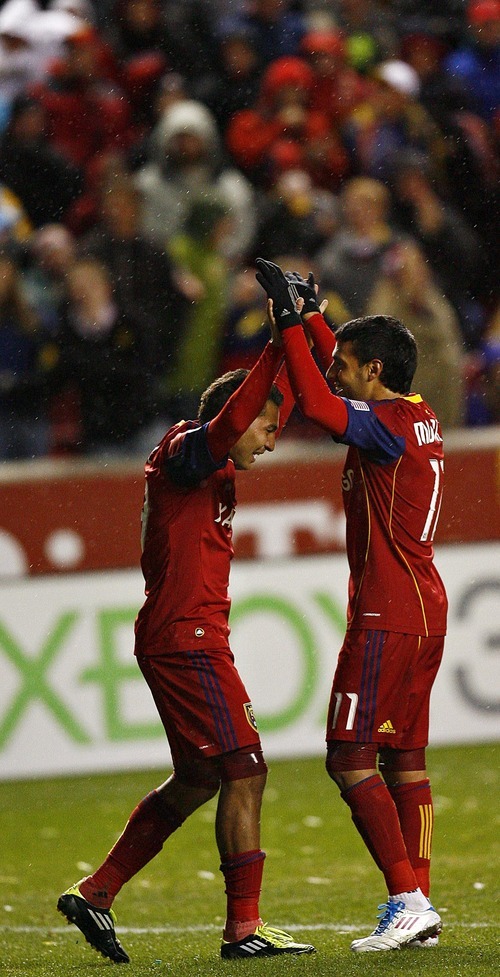 Djamila Grossman  |  The Salt Lake Tribune

Real Salt Lake's Javier Morales (11) and Paulo Araujo, Jr., react after their team scored a goal in the second half of a game against Los Angeles Galaxy during a game at Rio Tinto Stadium in Sandy, Utah, on Saturday,  March 26, 2011. RSL won the game.