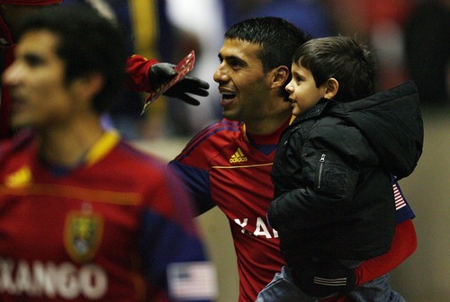 Djamila Grossman  |  The Salt Lake Tribune

Real Salt Lake's Javier Morales (11) greets fans as he carries his son, Santi, after RSL's win against Los Angeles Galaxy at Rio Tinto Stadium in Sandy, Utah, on Saturday,  March 26, 2011.