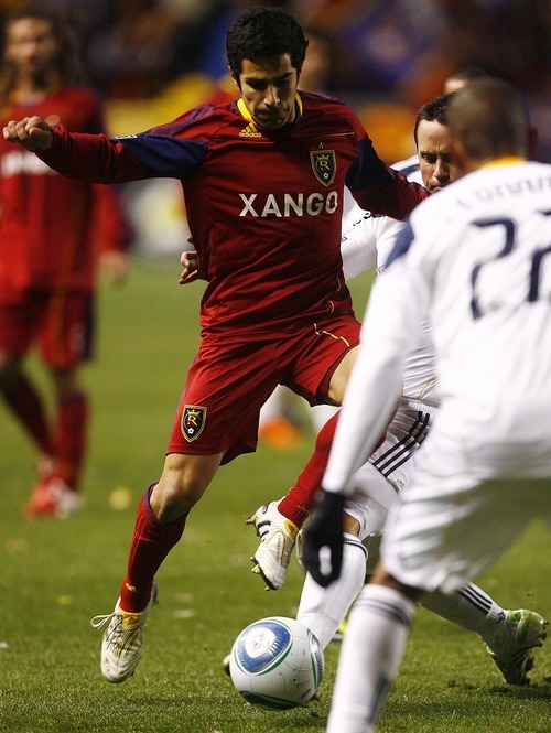 Djamila Grossman  |  The Salt Lake Tribune

Real Salt Lake's Tony Beltran (2) jumps over the legs of Los Angeles Galaxy's Todd Dunivant (2) during the second half of a game at Rio Tinto Stadium in Sandy, Utah, on Saturday,  March 26, 2011. RSL won the game.