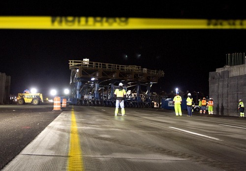 Djamila Grossman  |  The Salt Lake Tribune

Workers move the Sam White Bridge into place on I-15 at American Fork on Saturday, March 26, 2011. It is the longest two-span bridge ever moved on wheels - Self-Propelled Modular Transporters- in the western hemisphere.