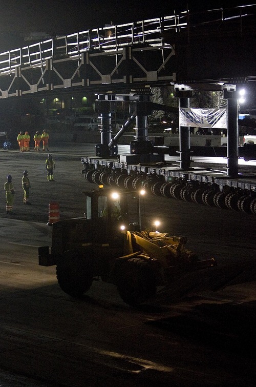 Djamila Grossman  |  The Salt Lake Tribune

Workers move the Sam White Bridge into place on I-15 at American Fork on Saturday, March 26, 2011. It is the longest two-span bridge ever moved on wheels - Self-Propelled Modular Transporters- in the western hemisphere.