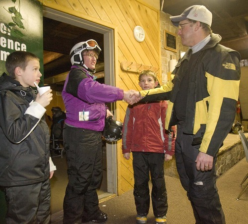 Paul Fraughton  |  The Salt Lake Tribune  
As Isaac Noel, 10, left, looks on, Rachael Shutt with her son, Dain, shakes hands with Canyons Superintendent David Doty at a meet-and-greet at Brighton Ski Resort.