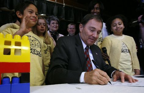 Francisco Kjolseth  |  The Salt Lake Tribune
Gov. Gary Herbert signs an education bill after highlighting Utah's efforts to fund education growth for the first time in three years by signing HB2, Minimum School Program and Public Education Budget Amendments at Taylorsville Elementary on Tuesday, March 29, 2011, in front of approximately 500 students. At left is J.P. Phillips, 10, and JoDeanna Warburton, 11, right who signed the bill as witness.