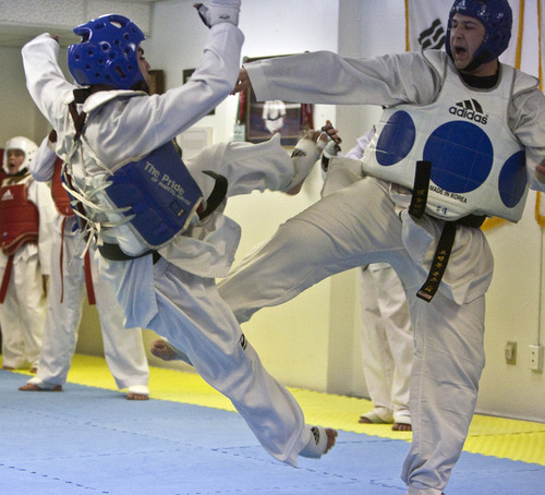 Chris Detrick | The Salt Lake Tribune 
Andres Pizarro spars with Brandon Jones with at Pace Academy Tae Kwon Do on Thursday.  Pizarro, a senior at Juan Diego Catholic High School, is a multiple Tae Kwon Do champion.