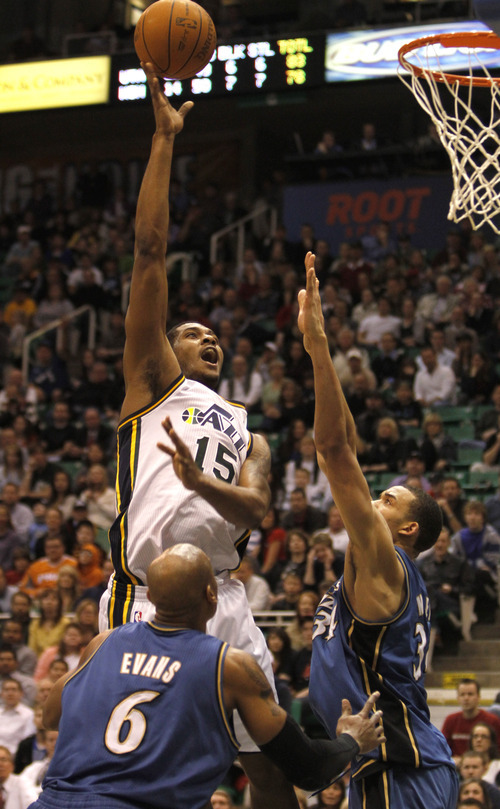 Rick Egan   |  The Salt Lake Tribune

Utah Jazz guard Derrick Favors (15)  scores over Maurice Evans, (6) and Washington Wizards center JaVale McGee (34)  in NBA action Utah vs Washington, in Salt Lake City, Monday, March 28, 2011. Wall was held scoreless in the second half of regulation play.