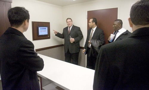 Paul Fraughton  |  The Salt Lake Tribune
 Jared Doxey, director of architecture, engineering and construction for the LDS Church, recently shows a group of LDS church members from around the globe the Farmington  West Stake Center, which is the church's pilot building for energy efficiency. Here he points out a display that shows the amount of energy the building is using in real time.