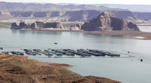 Boaters are dwarfed by the sandstone walls of Lake Powell. Tribune file photo