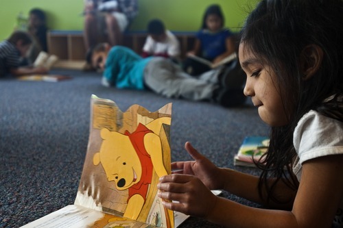 Chris Detrick | The Salt Lake Tribune 
Esmeralda Sanchez, 5, reads a book at the YMCA Community Family Center in Taylorsville on Wednesday, March 23, 2011.