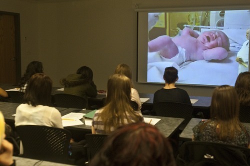 Chris Detrick | The Salt Lake Tribune 
Utah Career and Technical Education high school students watch a vaginal delivery and a caesarean birth Wednesday during a Virtual Healthcare Interactive live broadcast at the Granite Technical Institute on Wednesday, March 30, 2011. In partnership with the Utah State Office of Education (USOE) and Intermountain Healthcare, Utah Career and Technical Education students across the state participated in the event, which was followed by a live chat with physicians using real-time technology.