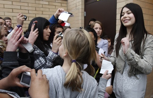 Rick Egan   |  The Salt Lake Tribune

 Miranda Cosgrove signs autogrphs at Crescent Elementary School in Sandy, Monday, March 28, 2011. Cosgrove, star of  TV show 