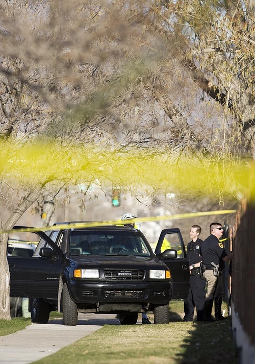 Djamila Grossman  |  The Salt Lake Tribune
Law enforcement officials examine an SUV at the scene of an officer-involved shooting in Salt Lake City,on Friday. A suspect in an armed robbery was shot and killed after a chase along 400 South.