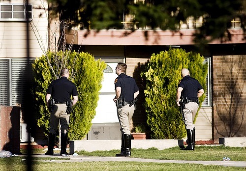 Djamila Grossman  |  The Salt Lake Tribune
Police officers stand in an apartment complex near the scene of an officer-involved shooting Friday in Salt Lake City. A man suspected in a bank robbery was shot and killed.