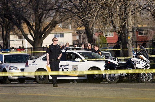 Djamila Grossman  |  The Salt Lake Tribune
Law enforcement officials work at the scene of an officer-involved shooting Friday in Salt Lake City. A man suspected in a bank robbery was shot and killed.