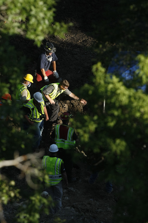 Crews search for the body of Victor Alanis, 13, at the site of the mudslide Tuesday July 14, 2009. Jacqueline Leavey, 43, and her daughter Abbey Alanis, 12, were found Tuesday afternoon.

Photo by Chris Detrick/The Salt Lake Tribune