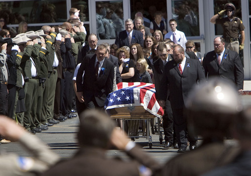 Steve Griffin  |  The Salt Lake Tribune&#xA; &#xA;Law enforcement officers salute as Shawna Harris and her daughters, Kristina and Kirsten follow the casket of her husband Kane County sheriff's Deputy Brian Harris as it is carried to the hearse outside Valley High School during funeral services  in Orderville, UT  Friday, September 3, 2010.