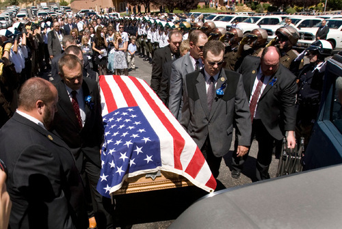 Steve Griffin  |  The Salt Lake Tribune
Shawna Harris is joined by daughters Kristina and Kirsten as they follow the casket of her husband, Kane County Sheriff's Deputy Brian Harris, Sept. 3 in Orderville.