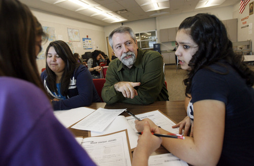 Francisco Kjolseth  |  The Salt Lake Tribune
Tim Bailey, center, an award winning teacher at Northwest Middle School in North Salt Lake City, UT, who teaches 8th grade U.S. History works on a project with his students Sara Davis, Samantha Rodriguez, and Tiarra Morales, all 13 from left, on Tuesday, March 22, 2011. Bailey has been giving the U.S. Department of Education input on possible revisions to the No Child Left Behind law.