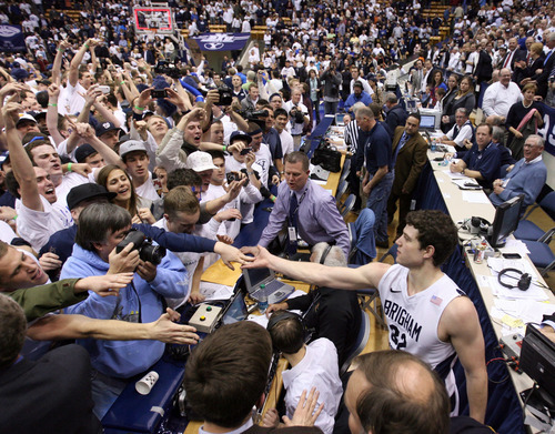 Steve Griffin  |  The Salt Lake Tribune
 
After fans stormed the court following BYU's victory over San Diego State on Jan. 26, Jimmer Fredette greets his admirers.
