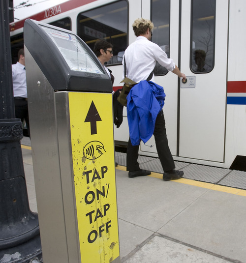 Al Hartmann   |  The Salt Lake Tribune 
With the Tap On-Tap Off device at the Rice Eccles Stadium TRAX station,  University of Utah students can use identification cards or credit cards as payment instead of using tokens.