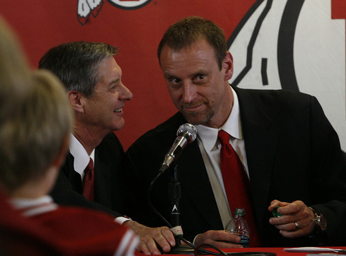 Scott Sommerdorf  |  The Salt Lake Tribune
Athletics director Chris Hill (left) speaks with the new men's basketball coach at the University of Utah - Larry Krystkowiak - after he was introduced at a press conference held at the University, Monday, April 4, 2011.