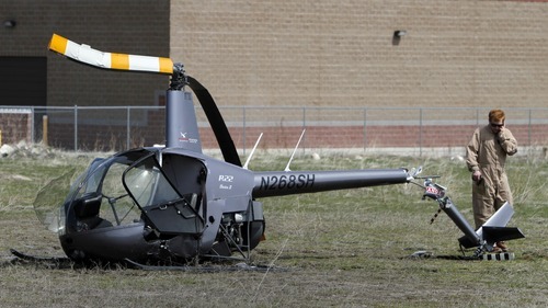 Rick Egan   |  The Salt Lake Tribune
A helicopter made a hard landing in a field near the South Valley Regional Airport in West Jordan Wednesday after its engine failed. The Upper Limit Aviation instructor and his student were treated at the scene.