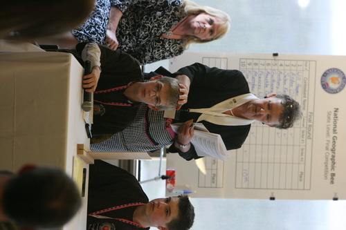 Leah Hogsten  |  The Salt Lake Tribune
Utah National Geographic Bee coordinator Sheila Keller-Powell touches the head of Will Hooper as he starts the competition April 1 at Thanksgiving Point. The Bonneville Elementary sixth-grader and World War II buff placed second behind Anthony Cheng for the second straight year.