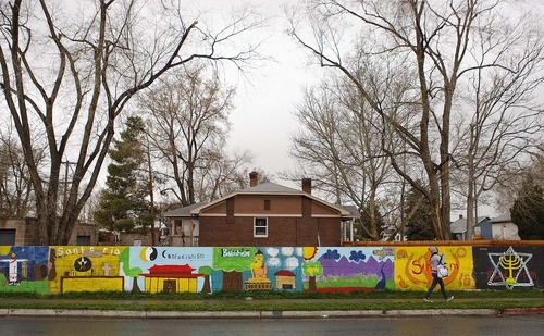 Trent Nelson  |  The Salt Lake Tribune
Jessi Cummings, a school teacher who lives in South Salt Lake, had a problem with gang graffiti on the wall surrounding her house. She decided to have some of her students at Taylorsville High paint over the graffiti with a mural of world religions. The mural has helped curb the graffiti problem on her wall.