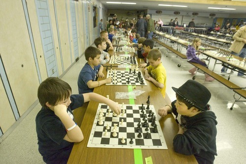 Paul Fraughton  |  The Salt Lake Tribune. Jacob Baldridge of Farnsworth Elementary, left, and Johnny Miller of Hunter Elementary, face off  at  West Valley City's first annual chess tournament at West Lake Junior High.