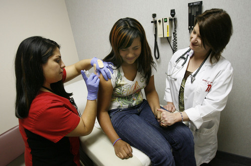 Francisco Kjolseth  |  The Salt Lake Tribune
Medical assistant April Trujillo, left, gives Marisela Raburn, 11, a round of vaccines for tetanus, meningitis and HPV alongside Pediatrician Cindy Gellner at Westridge Health Clinic in West Valley City on Tuesday, April 12, 2011. Recently there has been an outbreak of measles on the in the Mill Creek area but Doctor Gellner hasn't seen an increased concern from patients yet.