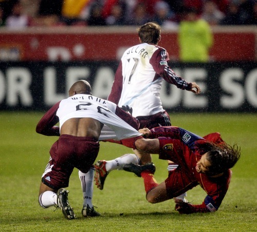 Steve Griffin  |  The Salt Lake Tribune
 
Real Salt Lake's Fabian Espindola grabs the jersey of  Colorado's Marvell Wynne as he falls to the ground during first half action in the Real Salt Lake versus Colorado Rapids at Rio Tinto Stadium in Sandy, Utah Wednesday, April 13, 2011.