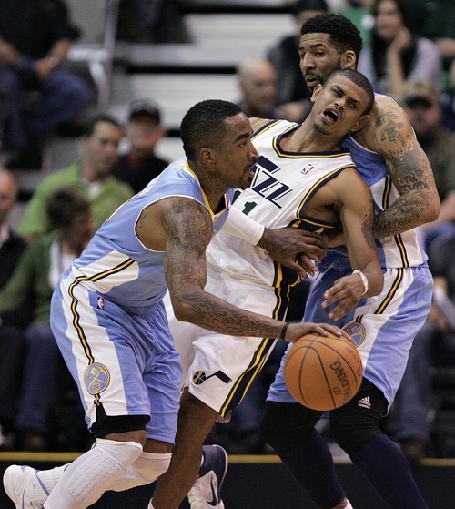 Djamila Grossman  |  The Salt Lake Tribune

The Utah Jazz' Earl Watson (11) gets pinched between the Denver Nuggets' J.R. Smith (5) and Wilson Chandler (21) during the second half of a game at Energy Solutions Arena in Salt Lake City, Utah, on Wednesday, April 13, 2011. The Jazz won the game.