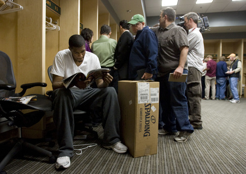 Steve Griffin  |  The Salt Lake Tribune
 
Jazz rookie Derrick Favors reads a magazine as media members surround Al Jefferson during locker clean-out day at EnergySolutions Arena in Salt Lake City on Thursday, April 14, 2011. The team finished its season last night and will not be going to the playoffs.
