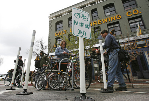 Francisco Kjolseth  |  The Salt Lake Tribune
Cyclist and the press show up for Salt Lake City Mayor Ralph Becker's unveiling of the city's first bike corral in front of Squatters Pub Brewery on Thursday.