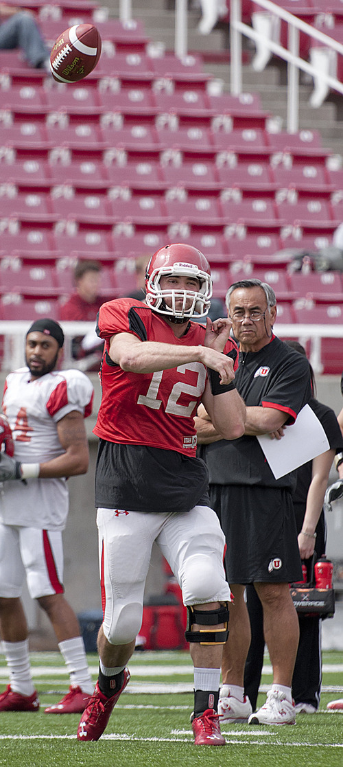 Michael Mangum  |  The Salt Lake Tribune

Utah sophomore quarterback Griff Robles throws while offensive coordinator Norm Chow, right, looks on during a spring practice session at Rice-Eccles Stadium on Monday, April 11, 2011.