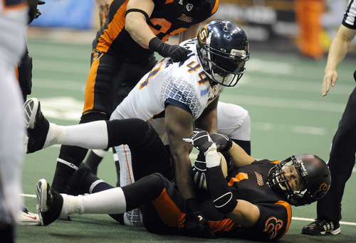 Sarah A. Miller  |  The Salt Lake Tribune

Utah Blaze's wide receiver Aaron Boone is tackled by Spokane's (44) Mike Alston Friday night at Energy Solutions Arena in downtown Salt Lake City.